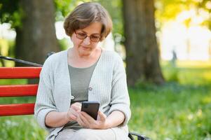 Smiling senior woman having recreation in park. photo