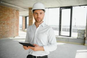 Close up engineers working on a building site holding a blueprints.Engineering and architecture concept photo