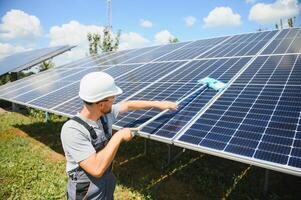 young worker cleaning solar panels. photo