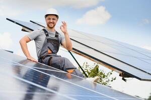 Worker installing solar panels outdoors photo