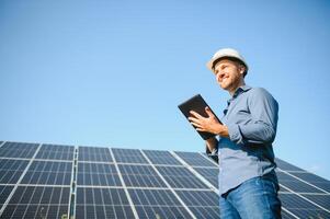 Solar power plant. Engineer on a background of photovoltaic panels. Science solar energy. photo