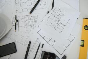 architect design working drawing sketch plans blueprints and making architectural construction model in architect studio,flat lay. photo