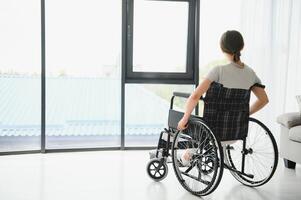 Young woman sitting in a wheelchair photo