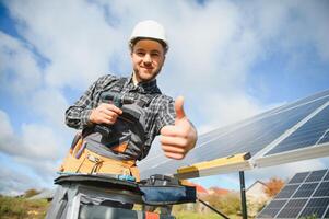 Worker installing solar panels outdoors photo