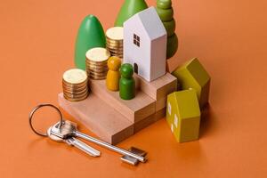 Conceptual composition of wooden steps with coins, model of a house photo