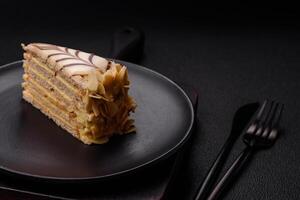 Piece of delicious sweet esterhazy cake with nuts and cream photo