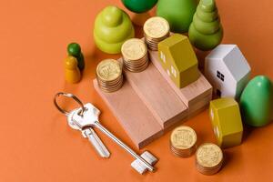 Conceptual composition of wooden steps with coins, model of a house photo