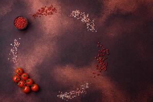 Empty concrete kitchen surface with salt, allspice and cherry tomatoes, copy space photo