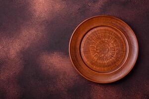 Empty ceramic round plate on dark textured concrete background photo