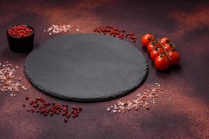 Empty ceramic round plate on dark textured concrete background photo