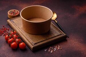 Empty ceramic round plate on dark textured concrete background photo