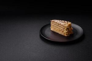 Piece of delicious sweet esterhazy cake with nuts and cream photo