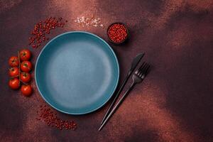 Empty ceramic round plate on dark textured concrete background photo