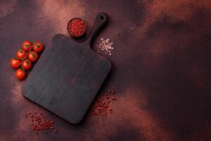 Empty rectangular wooden cutting board on textured concrete background photo