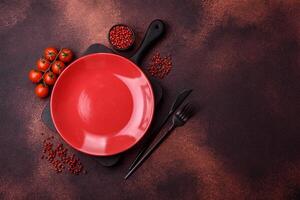 Empty ceramic round plate on dark textured concrete background photo