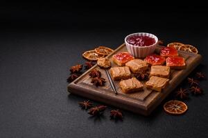 Delicious nutritious sandwiches with peanut butter, strawberry jam photo