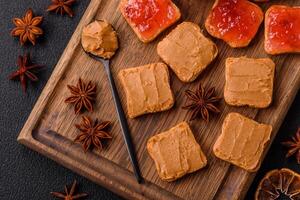 Delicious nutritious sandwiches with peanut butter, strawberry jam photo