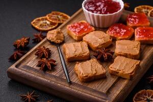 Delicious nutritious sandwiches with peanut butter, strawberry jam photo