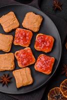 Delicious nutritious sandwiches with peanut butter, strawberry jam photo