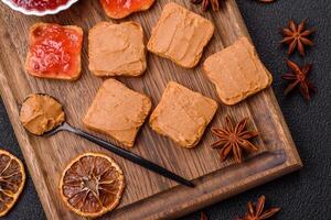 Delicious nutritious sandwiches with peanut butter, strawberry jam photo