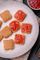 Delicious nutritious sandwiches with peanut butter, strawberry jam photo