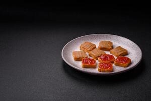 Delicious nutritious sandwiches with peanut butter, strawberry jam photo