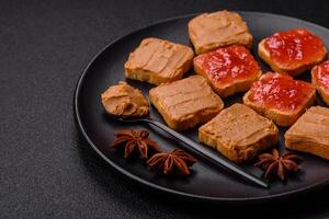 Delicious nutritious sandwiches with peanut butter, strawberry jam photo