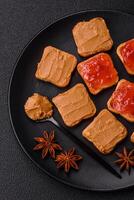 Delicious nutritious sandwiches with peanut butter, strawberry jam photo