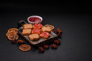 Delicious nutritious sandwiches with peanut butter, strawberry jam photo