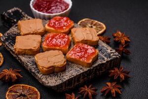 Delicious nutritious sandwiches with peanut butter, strawberry jam photo