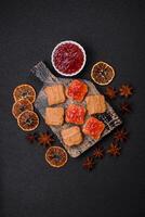 Delicious nutritious sandwiches with peanut butter, strawberry jam photo