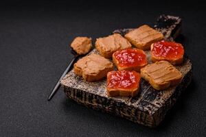 Delicious nutritious sandwiches with peanut butter, strawberry jam photo