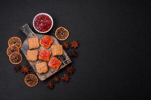 Delicious nutritious sandwiches with peanut butter, strawberry jam photo