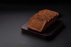 Delicious brown bread with seeds and grains cut into slices photo