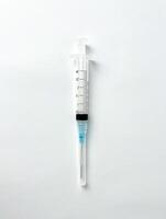 Syringe for injection photography isolated on vertical ratio plain white studio background. photo