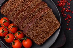 Delicious brown bread with seeds and grains cut into slices photo