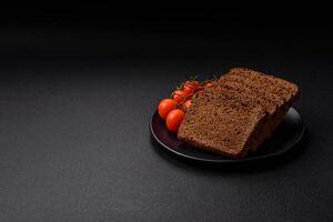 Delicious brown bread with seeds and grains cut into slices photo