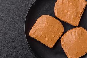 Delicious hearty sandwich with toast bread and peanut butter photo