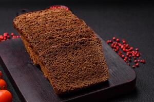 Delicious brown bread with seeds and grains cut into slices photo