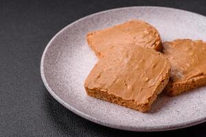 Delicious hearty sandwich with toast bread and peanut butter photo