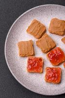 Delicious nutritious sandwiches with peanut butter, strawberry jam photo