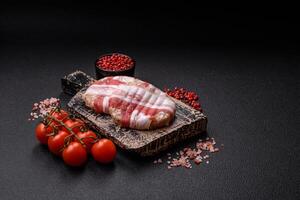 Round minced chicken or pork cutlet wrapped in bacon with salt, spices and herbs photo