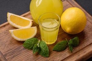 Alcoholic drink yellow limoncello in a small glass photo