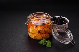 Delicious soft white feta cheese with salt, spices and herbs on a dark concrete background photo