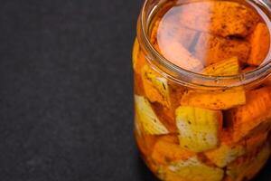 Delicious soft white feta cheese with salt, spices and herbs on a dark concrete background photo