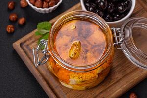 Delicious soft white feta cheese with salt, spices and herbs on a dark concrete background photo