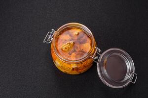 Delicious soft white feta cheese with salt, spices and herbs on a dark concrete background photo