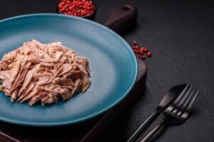 Delicious canned dietary tuna meat with salt, spices and oil photo