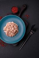 Delicious canned dietary tuna meat with salt, spices and oil photo