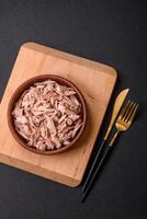 Delicious canned dietary tuna meat with salt, spices and oil photo